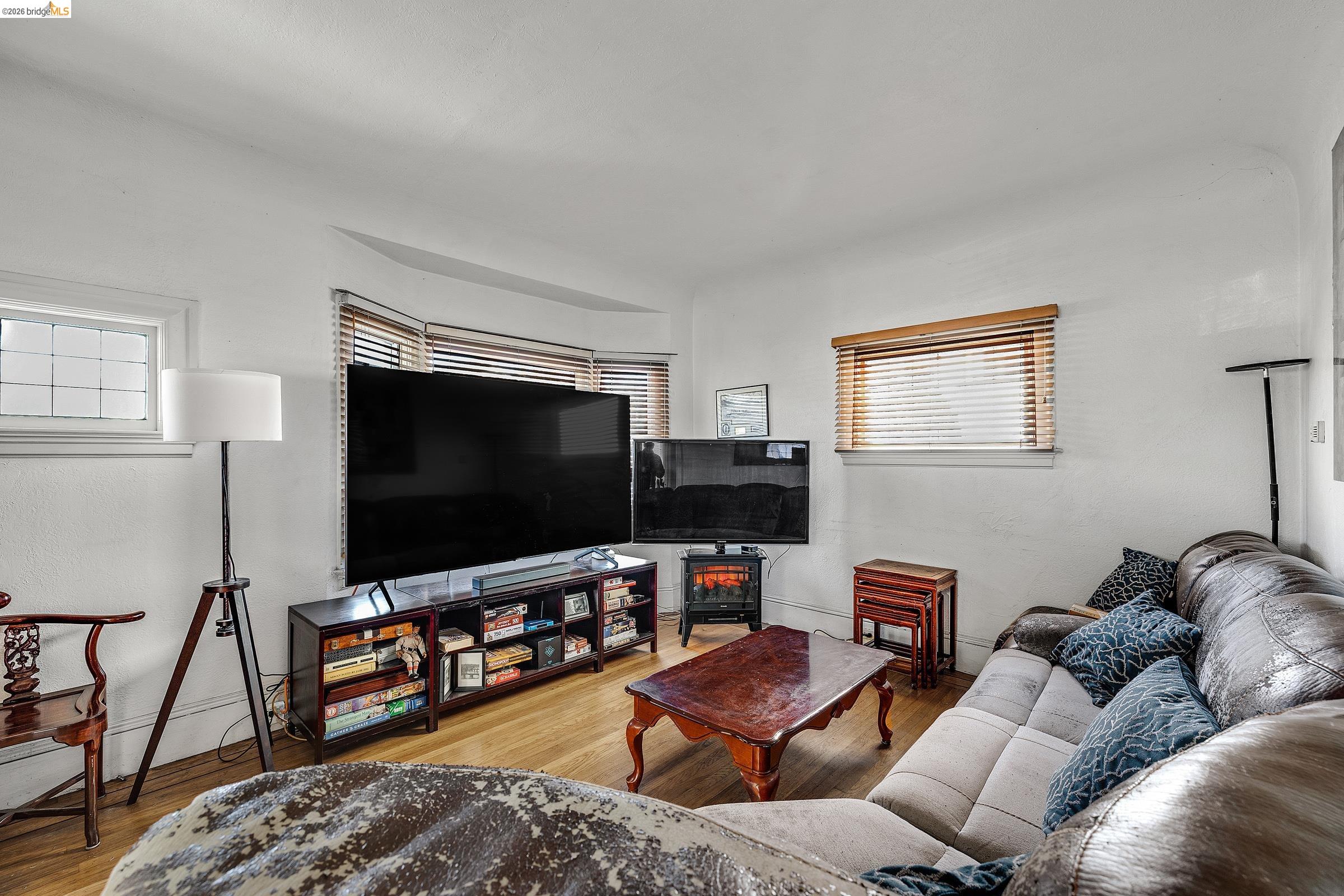 976 Park Street Alameda, CA 94501 - Photo 2 of 36 a living room with furniture and a flat screen tv