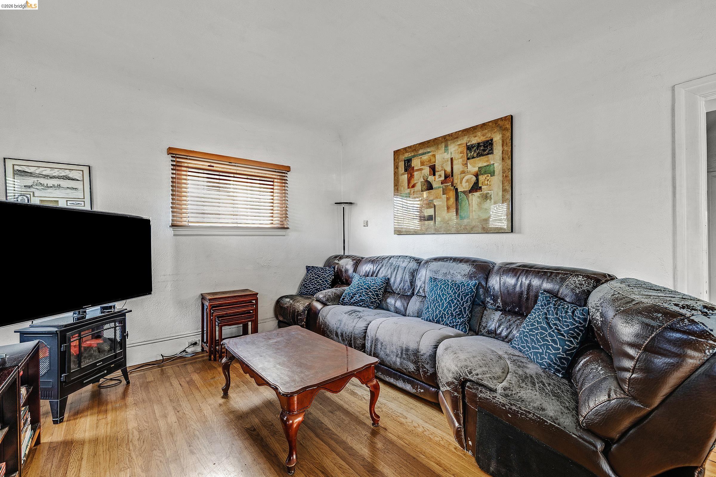 976 Park Street Alameda, CA 94501 - Photo 3 of 36 a living room with furniture and a flat screen tv