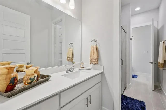 a en suite bathroom with a double vanity sink and a mirror