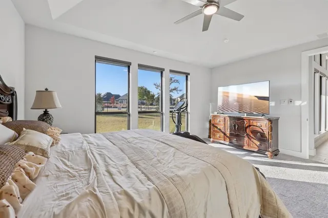 a bedroom with a large bed and a tv