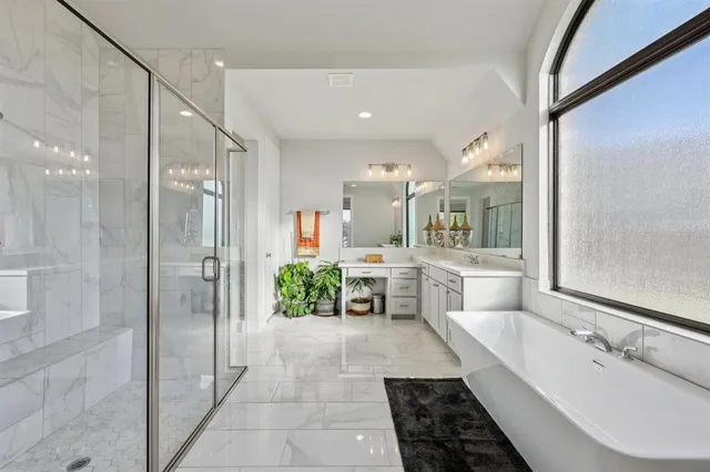 a large bathroom with a large tub shower and sink