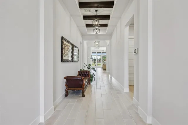 a hallway with furniture and wooden floor