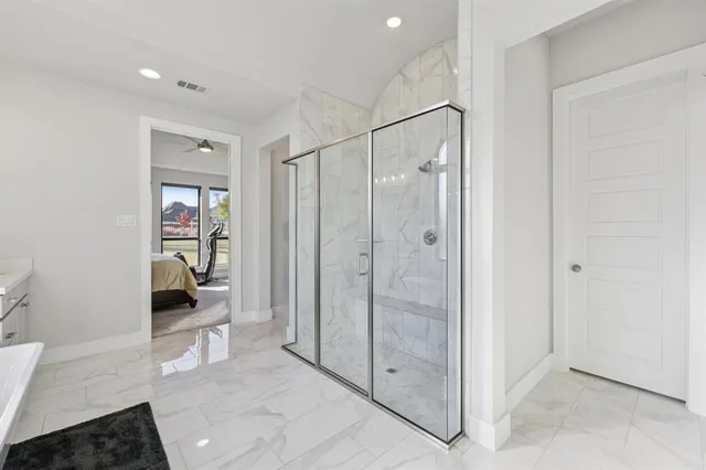a view of a bathroom with a shower and a sink