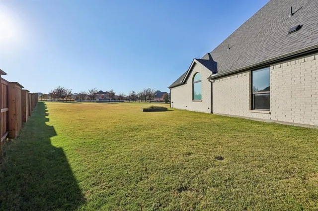 a house with yard and ocean view