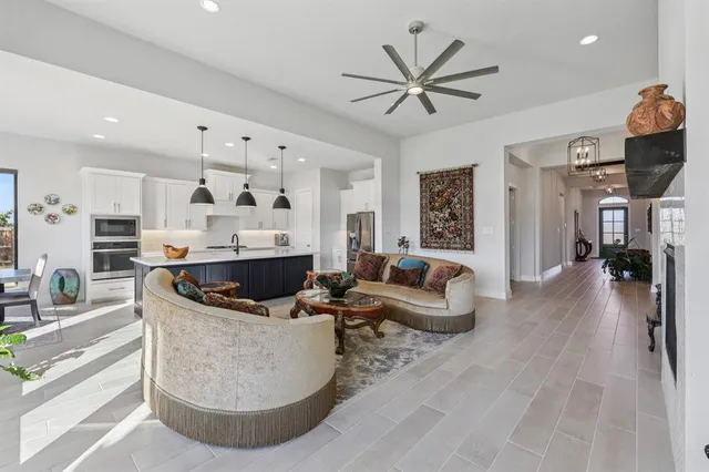 a living room with stainless steel appliances kitchen island furniture and a view of kitchen