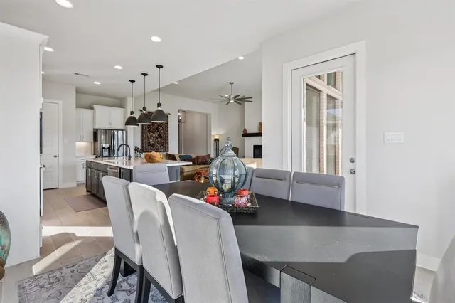 a living room with kitchen island furniture and a chandelier