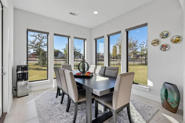a view of a dining room with furniture large windows and wooden floor