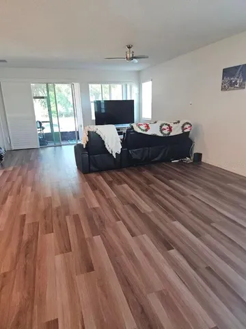 a living room with a bed furniture and a large window