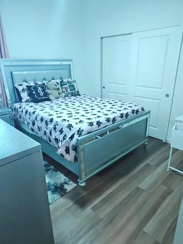 a bed sitting in a bedroom next to a bathroom