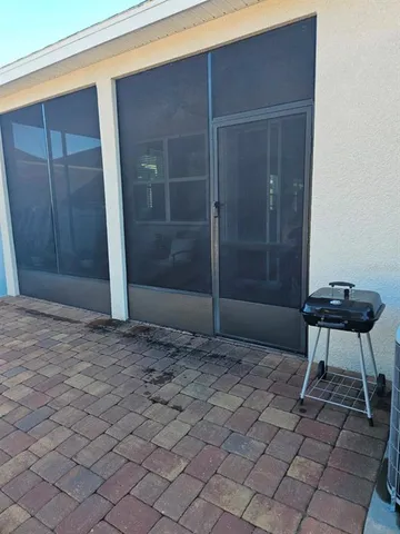 a view of an empty room with wooden floor and a carpet