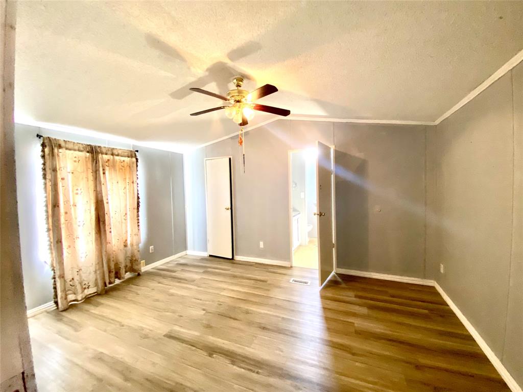100 South Beltline Road, Unit 79 Dallas, TX 75253 - Photo 9 of 15 a view of an empty room with wooden floor and a window