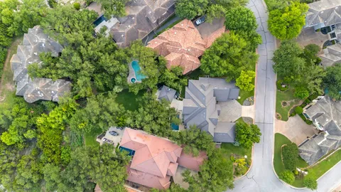 an aerial view of a house with a yard and lake view