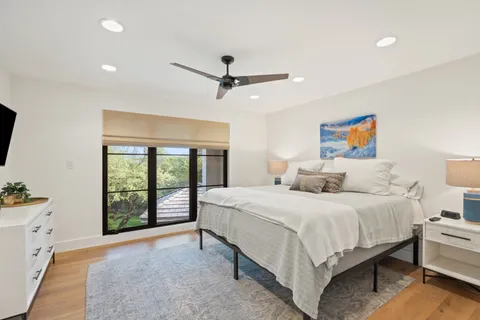 a bedroom with a large bed and a window