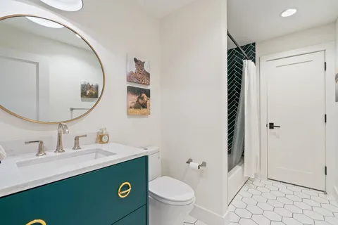 a bathroom with a sink toilet and mirror