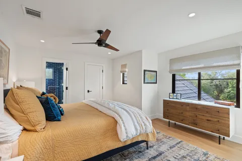 a bedroom with a bed and a large window