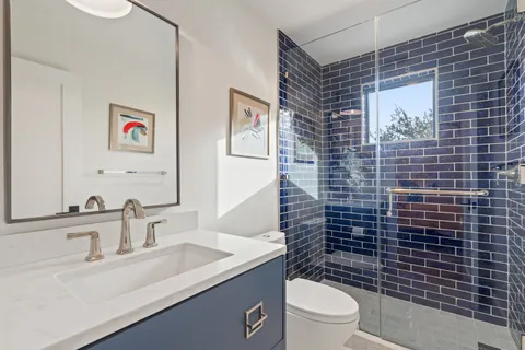 a bathroom with a sink toilet and shower