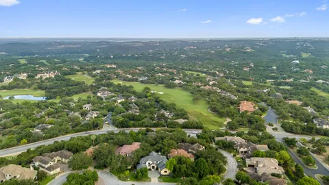 an aerial view of residential houses with city view