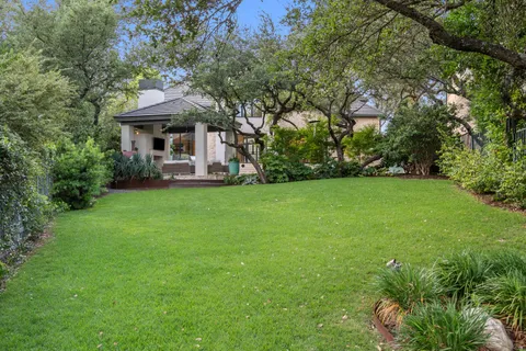 a view of a house with a yard and sitting area