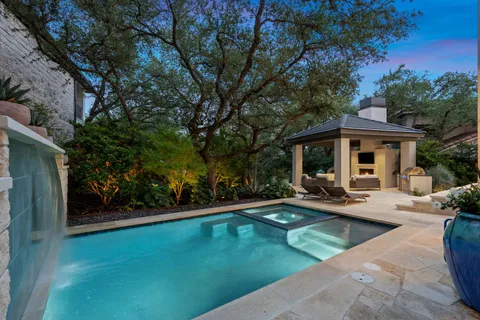 a view of a house with swimming pool and sitting area