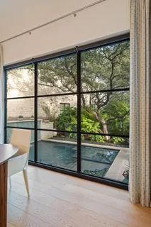 a view of a floor to ceiling window next to a yard