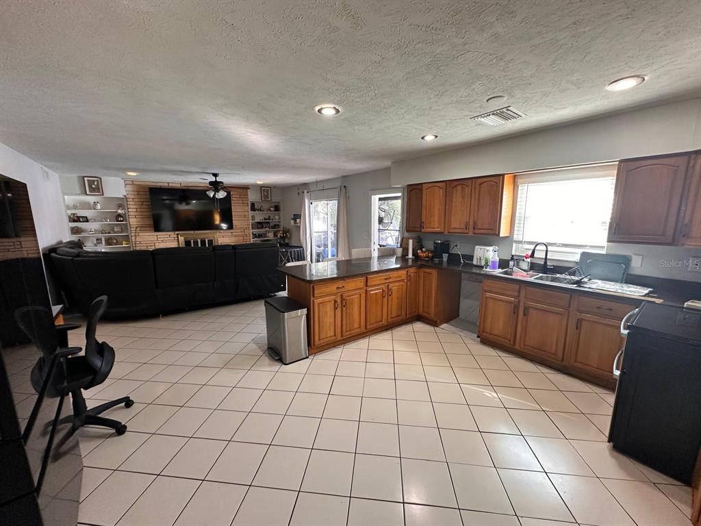 613 Royal Crest Way Brandon, FL 33511 - Photo 16 of 50 a kitchen with a sink a counter top space cabinets and stainless steel appliances