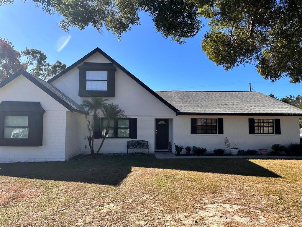 613 Royal Crest Way Brandon, FL 33511 - Photo 19 of 50 a front view of house with yard and trees in the background
