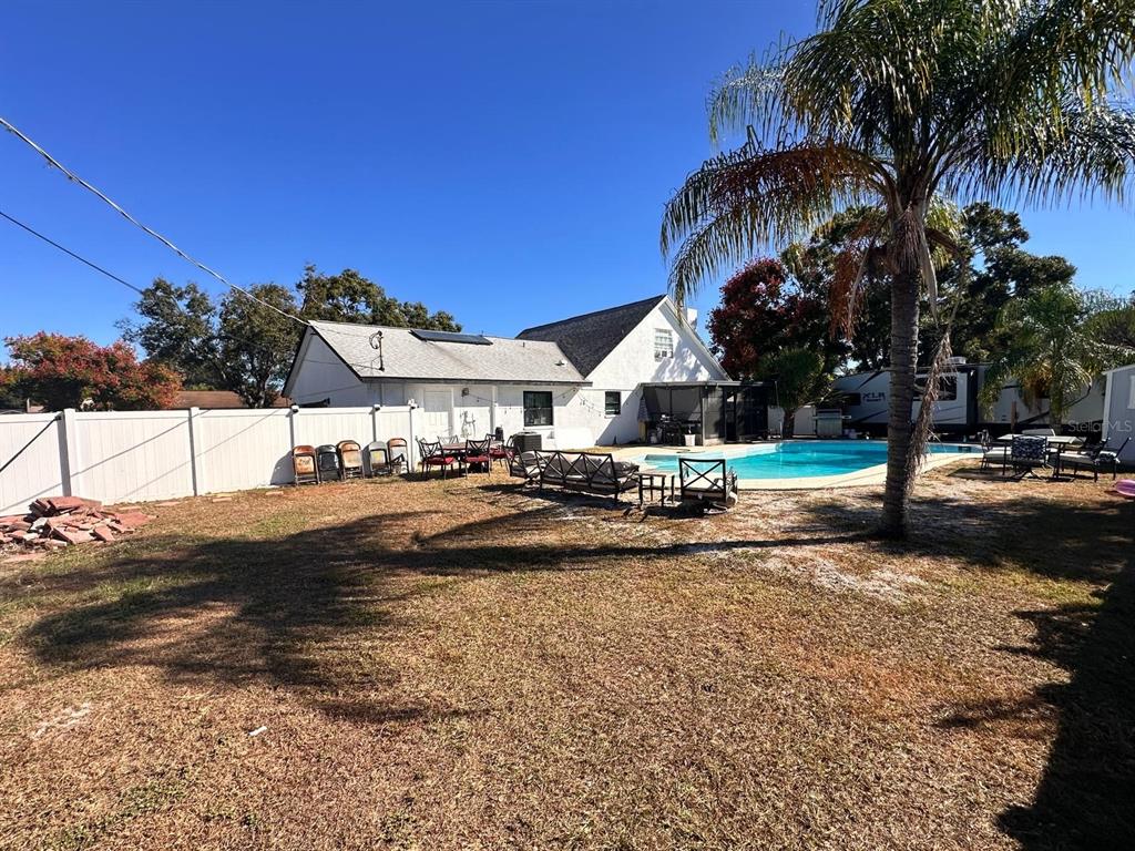 613 Royal Crest Way Brandon, FL 33511 - Photo 24 of 50 a view of swimming pool with lawn chairs and palm trees