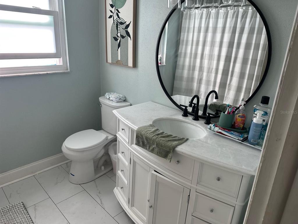 613 Royal Crest Way Brandon, FL 33511 - Photo 40 of 50 a bathroom with a sink a toilet and a mirror