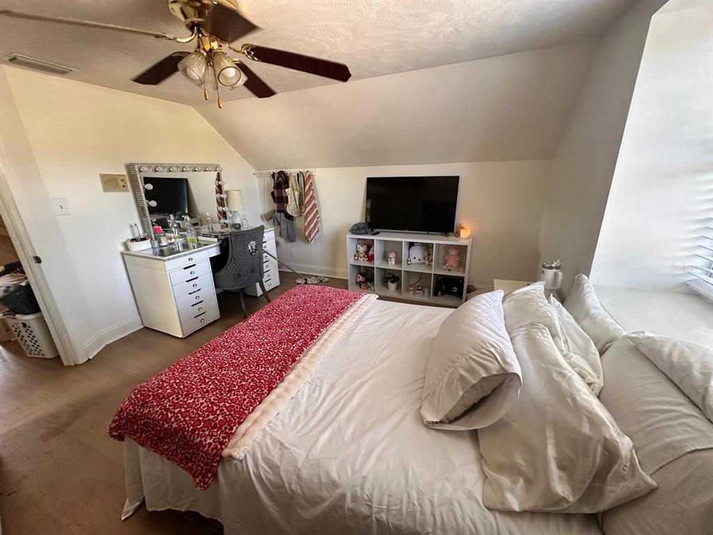 613 Royal Crest Way Brandon, FL 33511 - Photo 44 of 50 a bedroom with a bed and flat screen tv