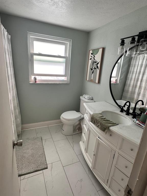 613 Royal Crest Way Brandon, FL 33511 - Photo 6 of 50 a bathroom with a granite countertop sink a mirror and a toilet