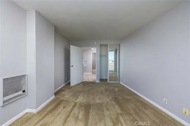 a view of empty room with window and fireplace