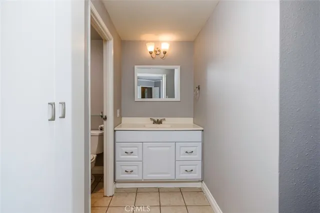 a bathroom with a sink a vanity and a mirror