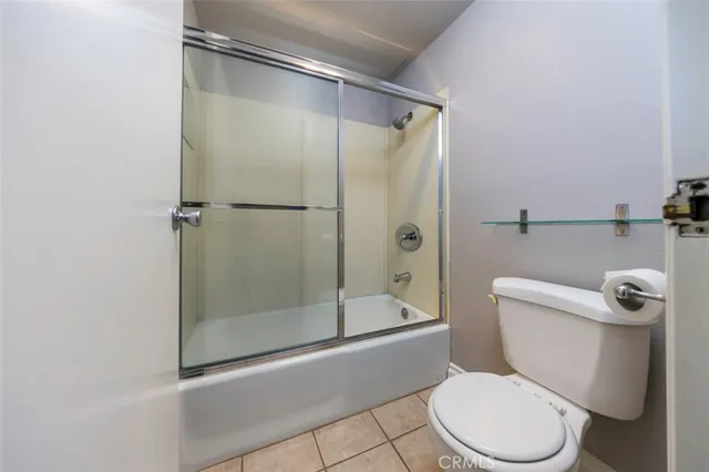 a white toilet sitting next to a bath tub