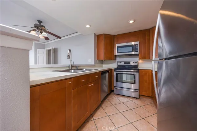 a kitchen with stainless steel appliances a stove a sink and a refrigerator