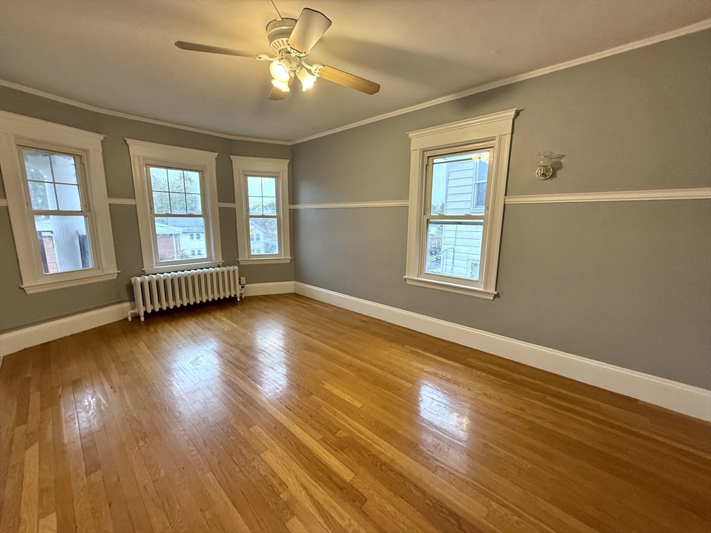 4 Adams Avenue, Unit 2 Watertown, MA 02472 - Photo 13 of 32 a view of empty room with wooden floor and fan