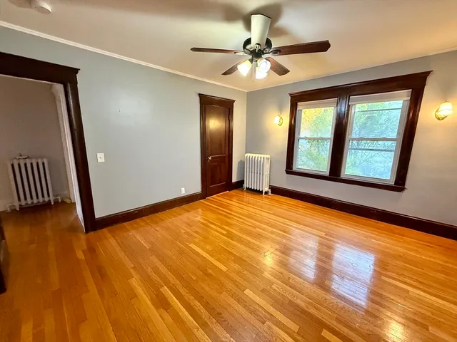 wooden floor in an empty room with a window