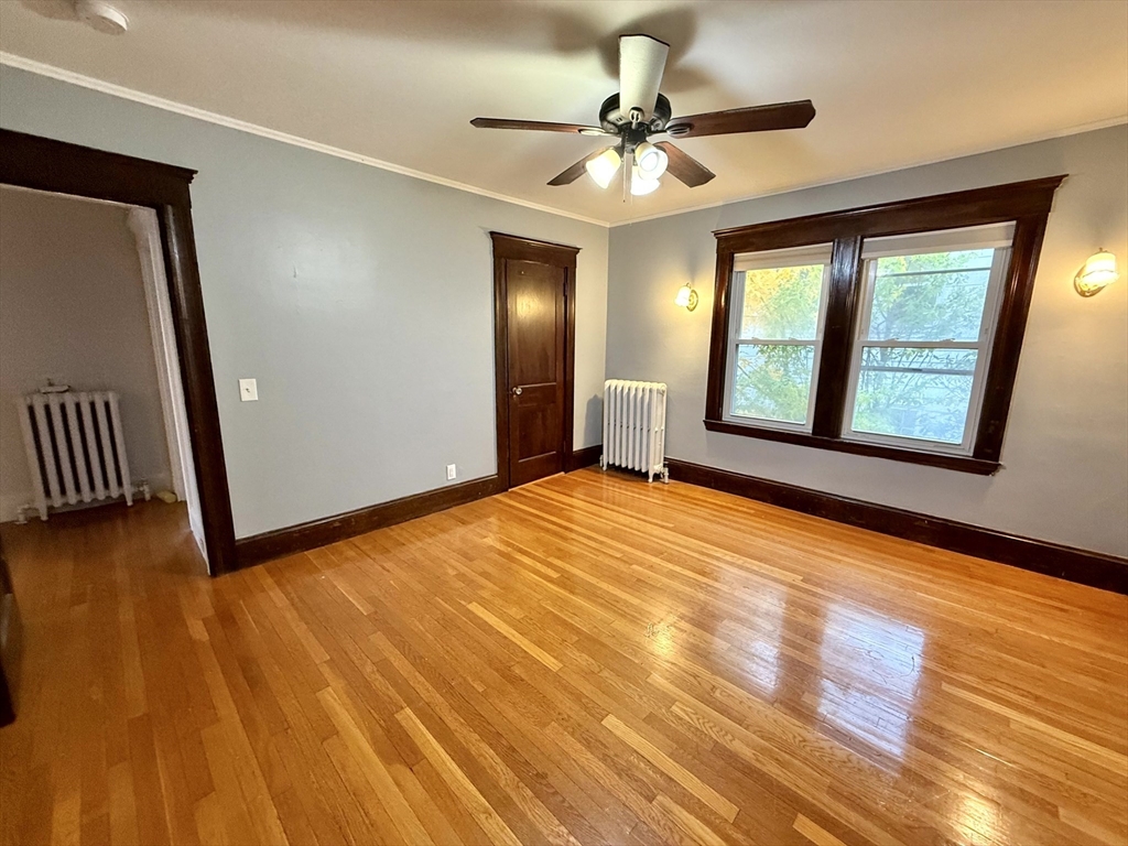 4 Adams Avenue, Unit 2 Watertown, MA 02472 - Photo 19 of 32 a view of empty room with wooden floor and fan