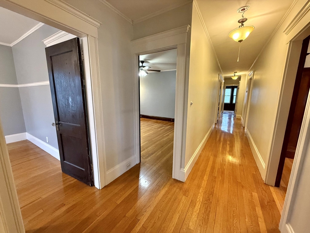 4 Adams Avenue, Unit 2 Watertown, MA 02472 - Photo 23 of 32 a view of a hallway with wooden floor and staircase