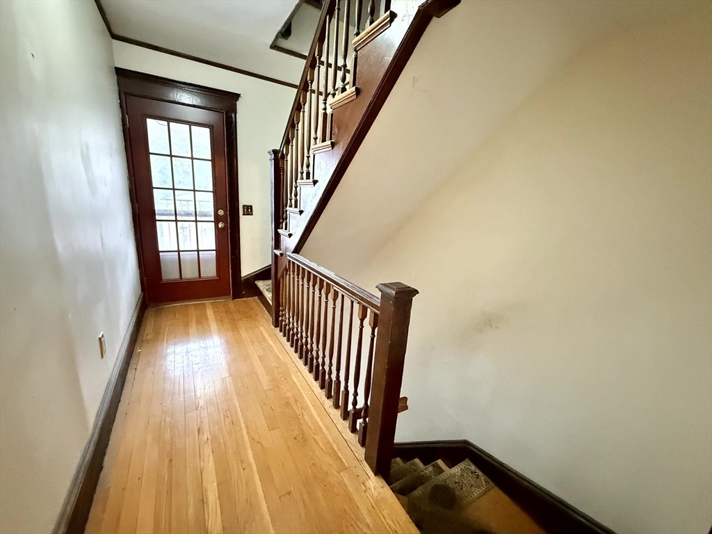 4 Adams Avenue, Unit 2 Watertown, MA 02472 - Photo 24 of 32 a view of a hallway with wooden floor and staircase