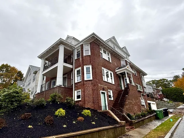 a view of a house with a small yard