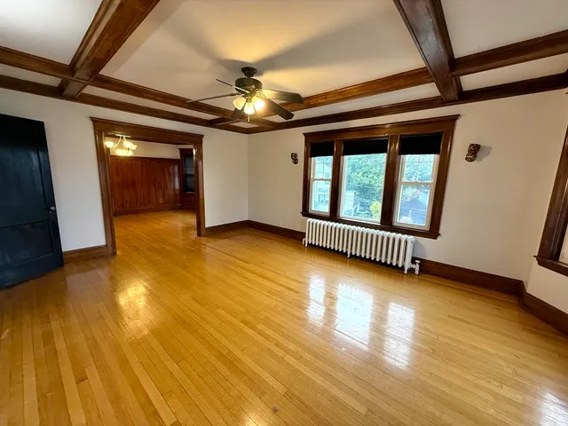 a view of a room with wooden floor and stairs