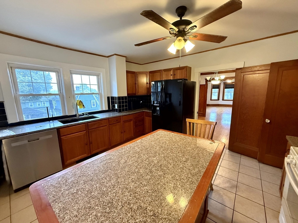 4 Adams Avenue, Unit 2 Watertown, MA 02472 - Photo 8 of 32 a kitchen with stainless steel appliances kitchen island granite countertop a refrigerator and a sink