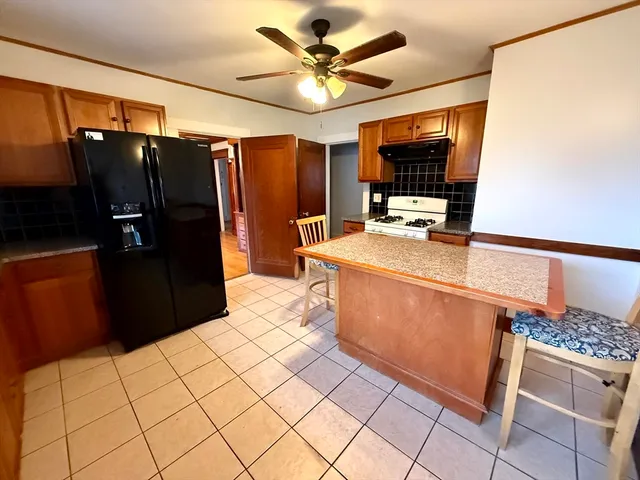 a kitchen with stainless steel appliances a refrigerator and a stove top oven
