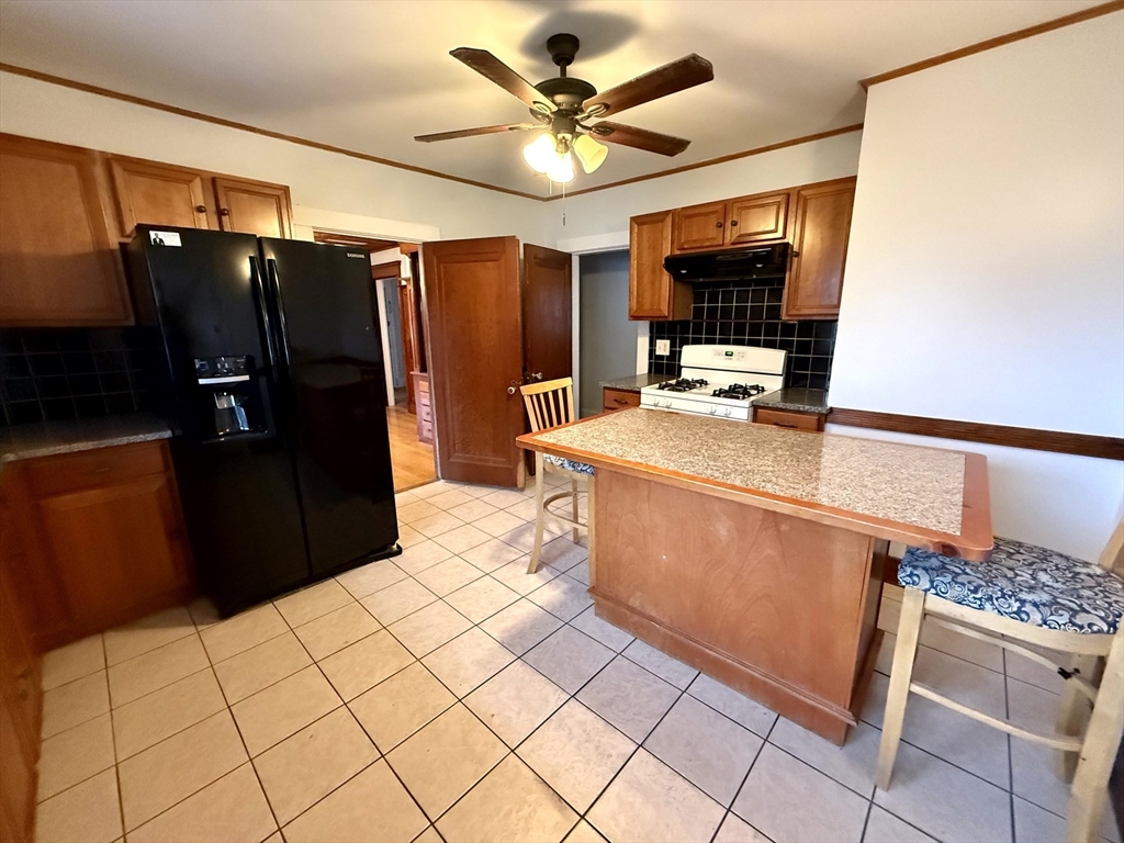 4 Adams Avenue, Unit 2 Watertown, MA 02472 - Photo 9 of 32 a kitchen with stainless steel appliances a refrigerator and a stove top oven