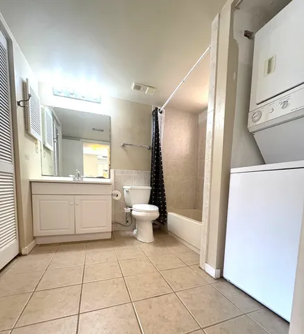 a white bath tub sitting next to a white sink and vanity