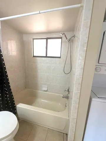a bathroom with a toilet a bath tub and a shower
