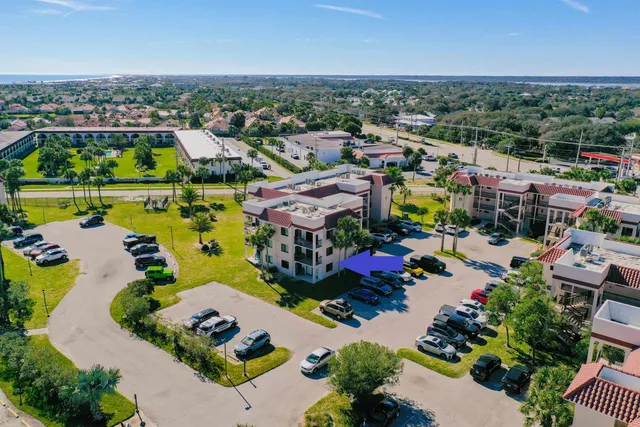 an aerial view of a houses with a swimming pool