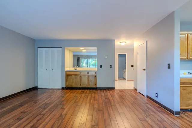 a view of a room with wooden floor and a bathroom