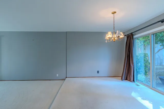 a view of an empty room with a chandelier