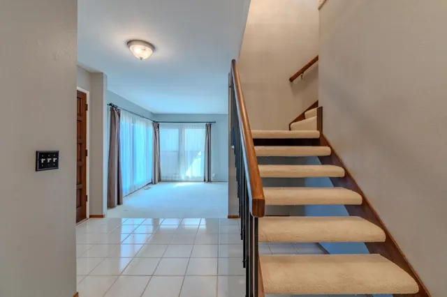 a view of staircase with white walls and windows
